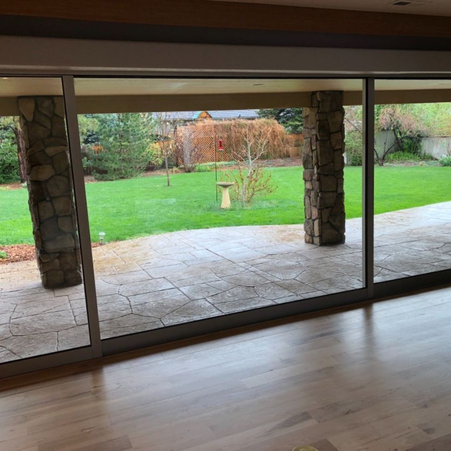 a living room with a sliding glass door leading to a patio .