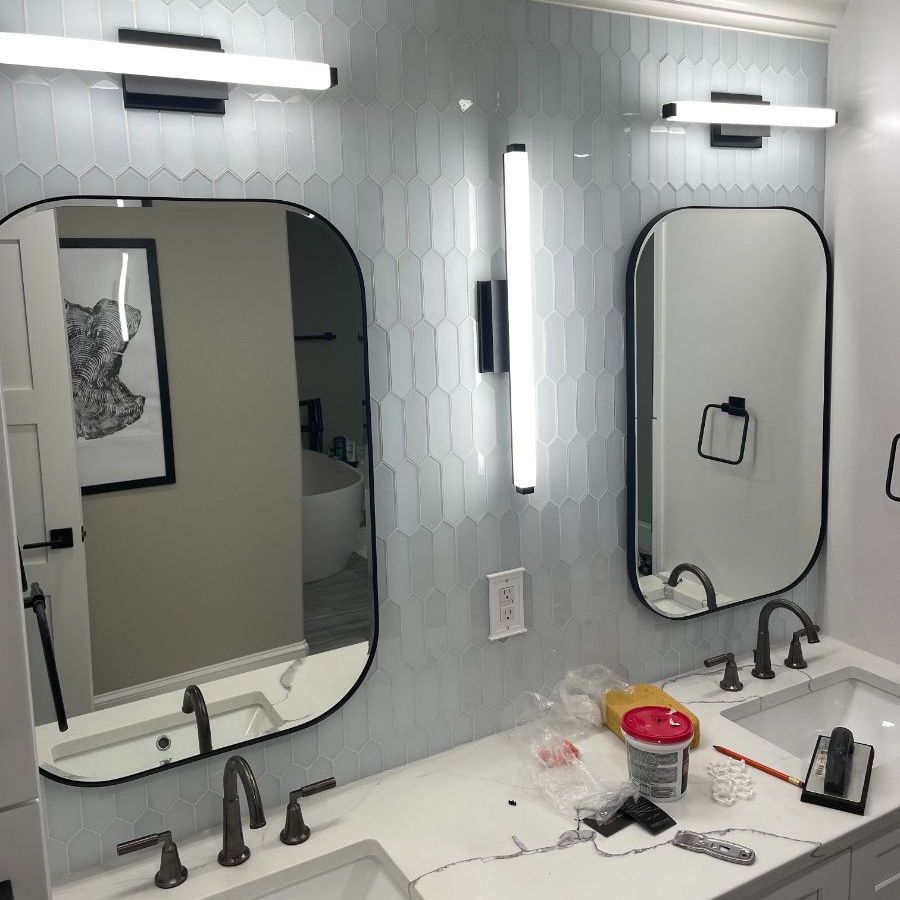 a bathroom with two sinks and two mirrors .