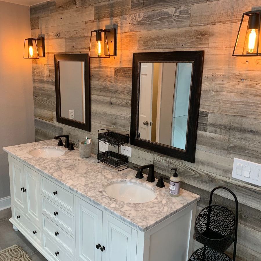 a renovated bathroom with two sinks and two mirrors .