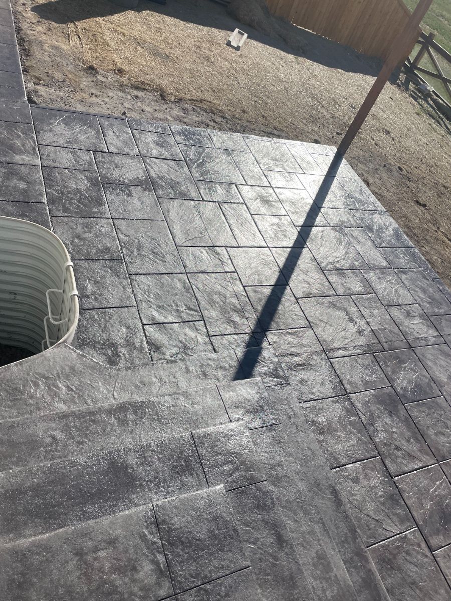 a shadow of a pole is cast on a concrete floor .