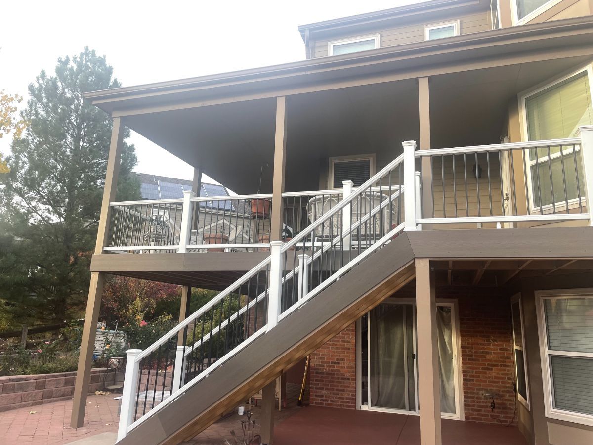 a house with a deck and stairs leading up to it .