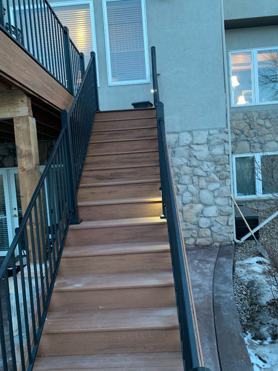 a set of wooden stairs leading up to a stone building .