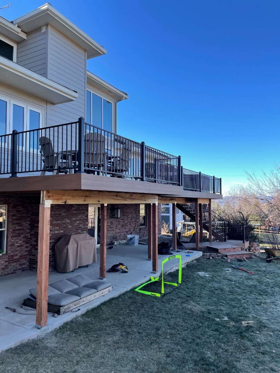 a large house with a large deck in the backyard .
