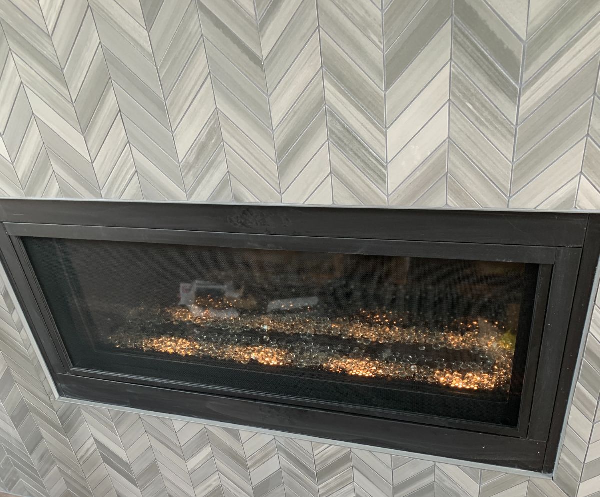 a fireplace with a herringbone pattern on the wall in Roxborough