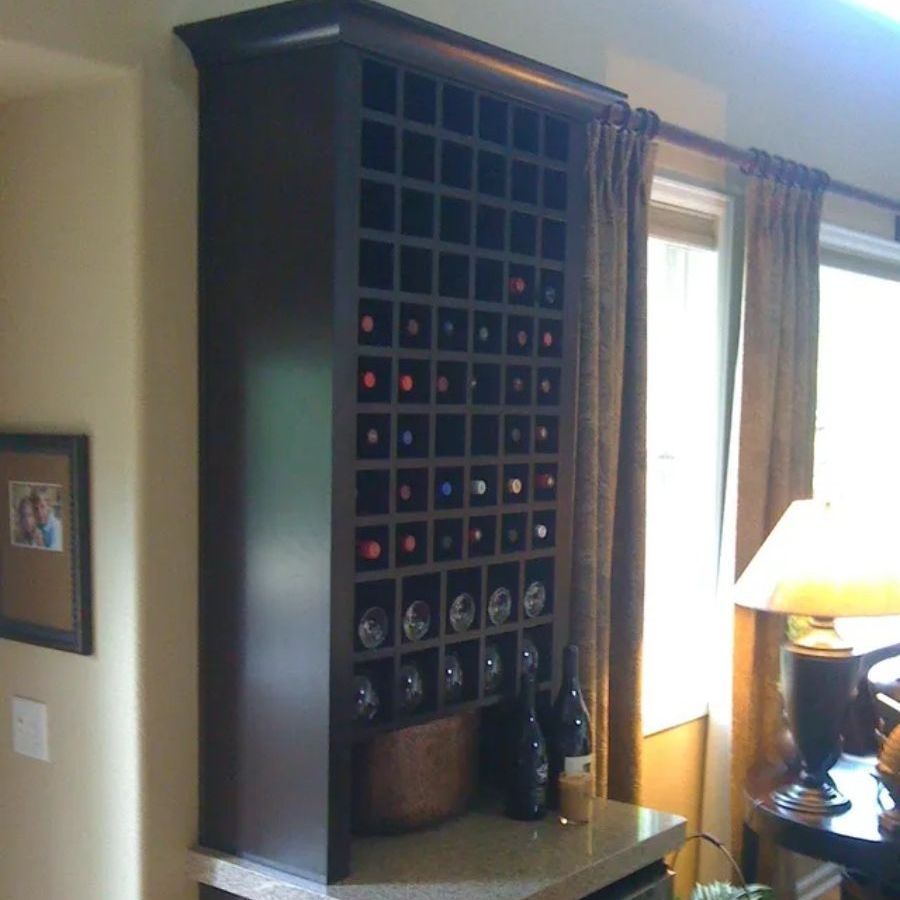 a living room with a wine rack and a lamp