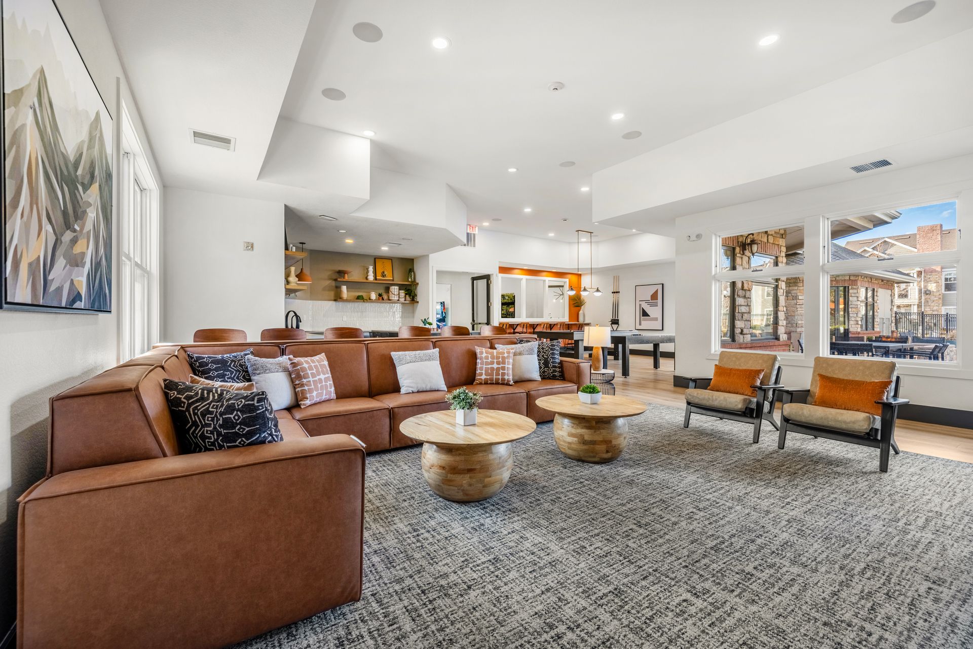 Clubhouse at Briargate on Main with seating area, wall art, and a digital fireplace.