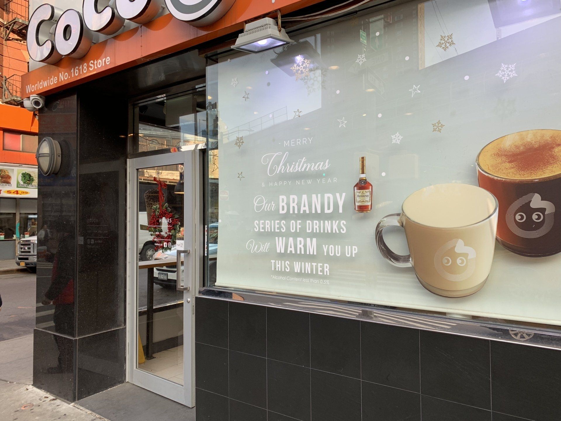 A store front with a christmas advertisement on the window.