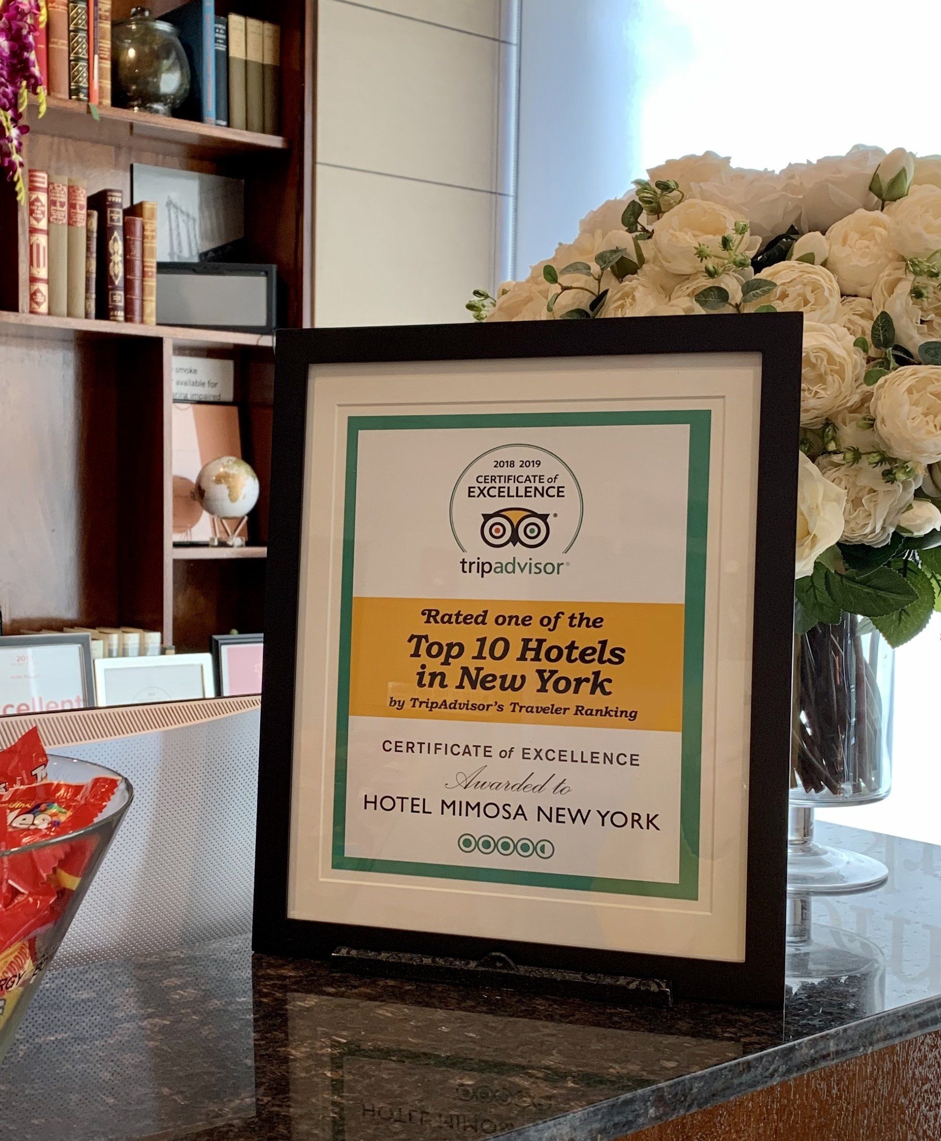 A framed sign that says submit me of the top 10 hotels in new york