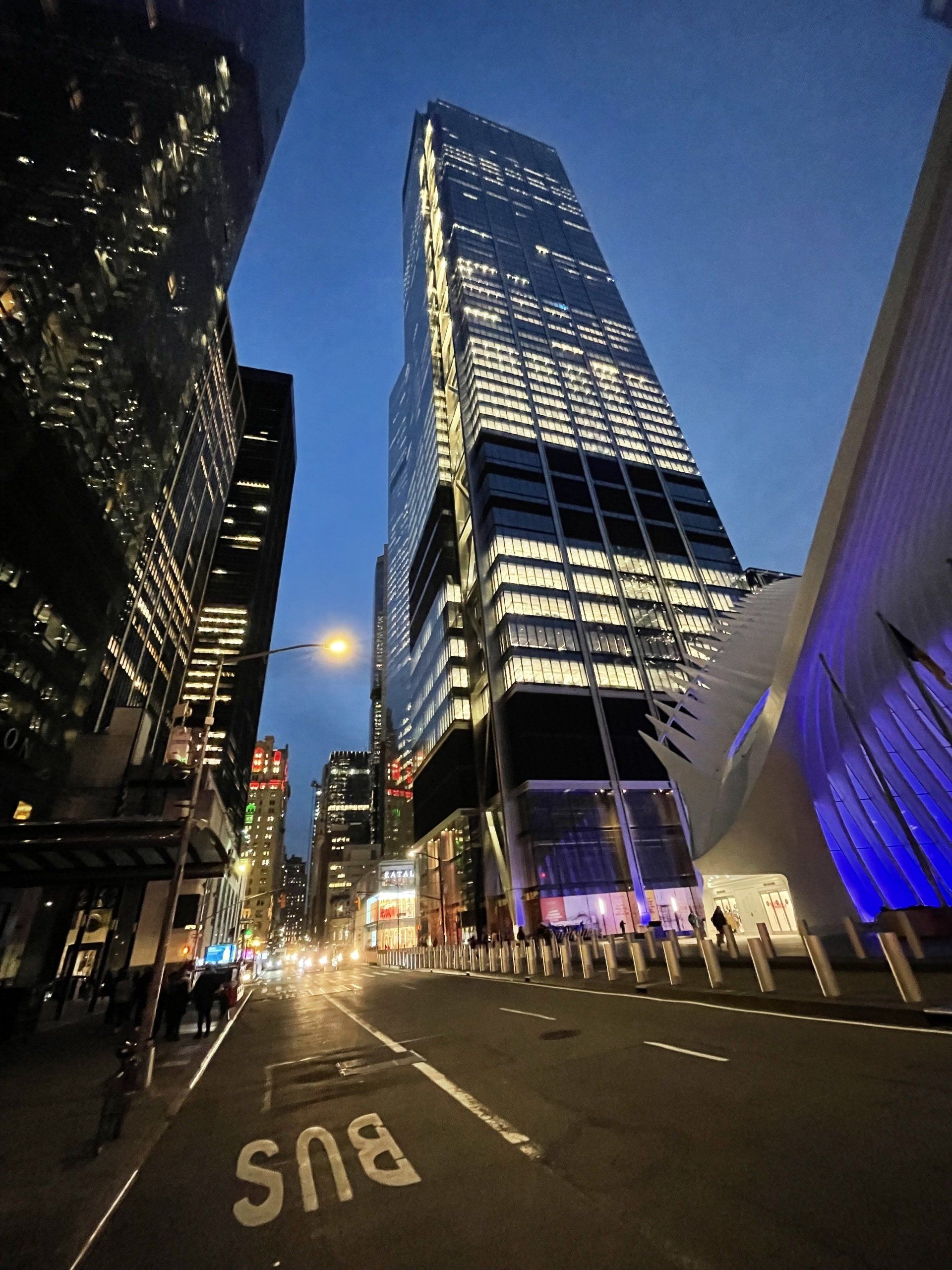 Looking up at a bus stop in a city at night