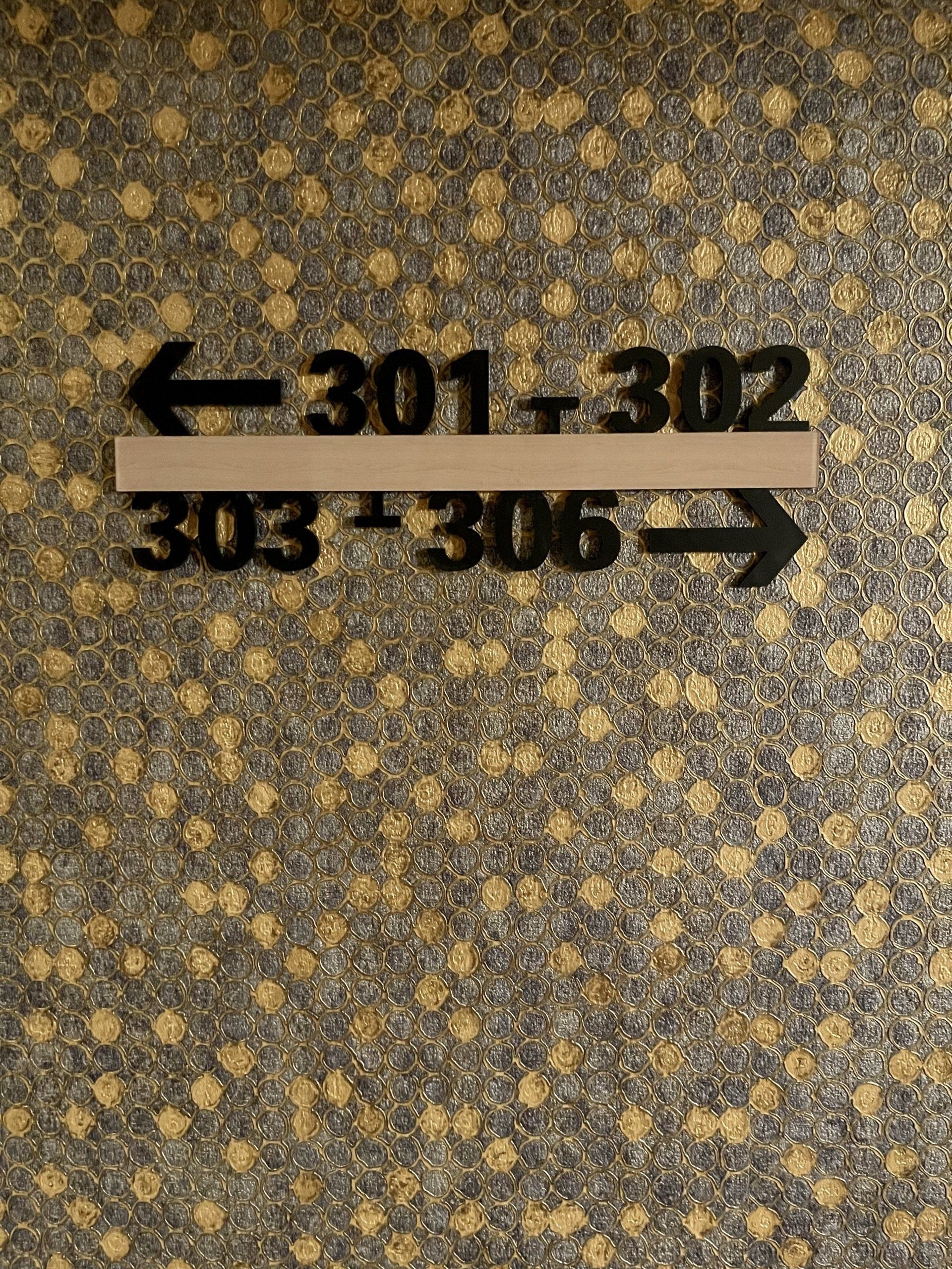 A sign on a wall that says 301 302 303 306
