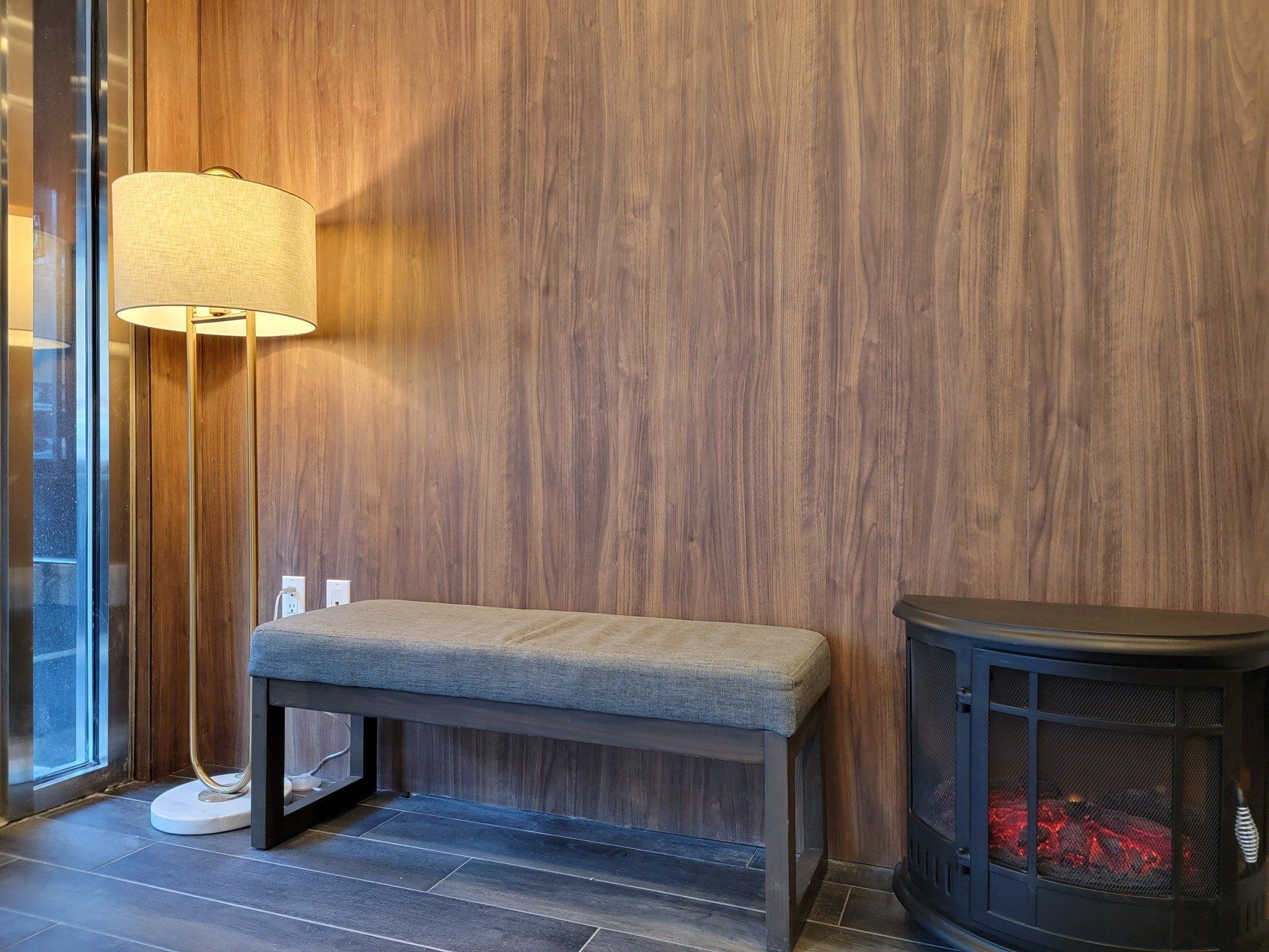 There is a bench and a fireplace in the room.