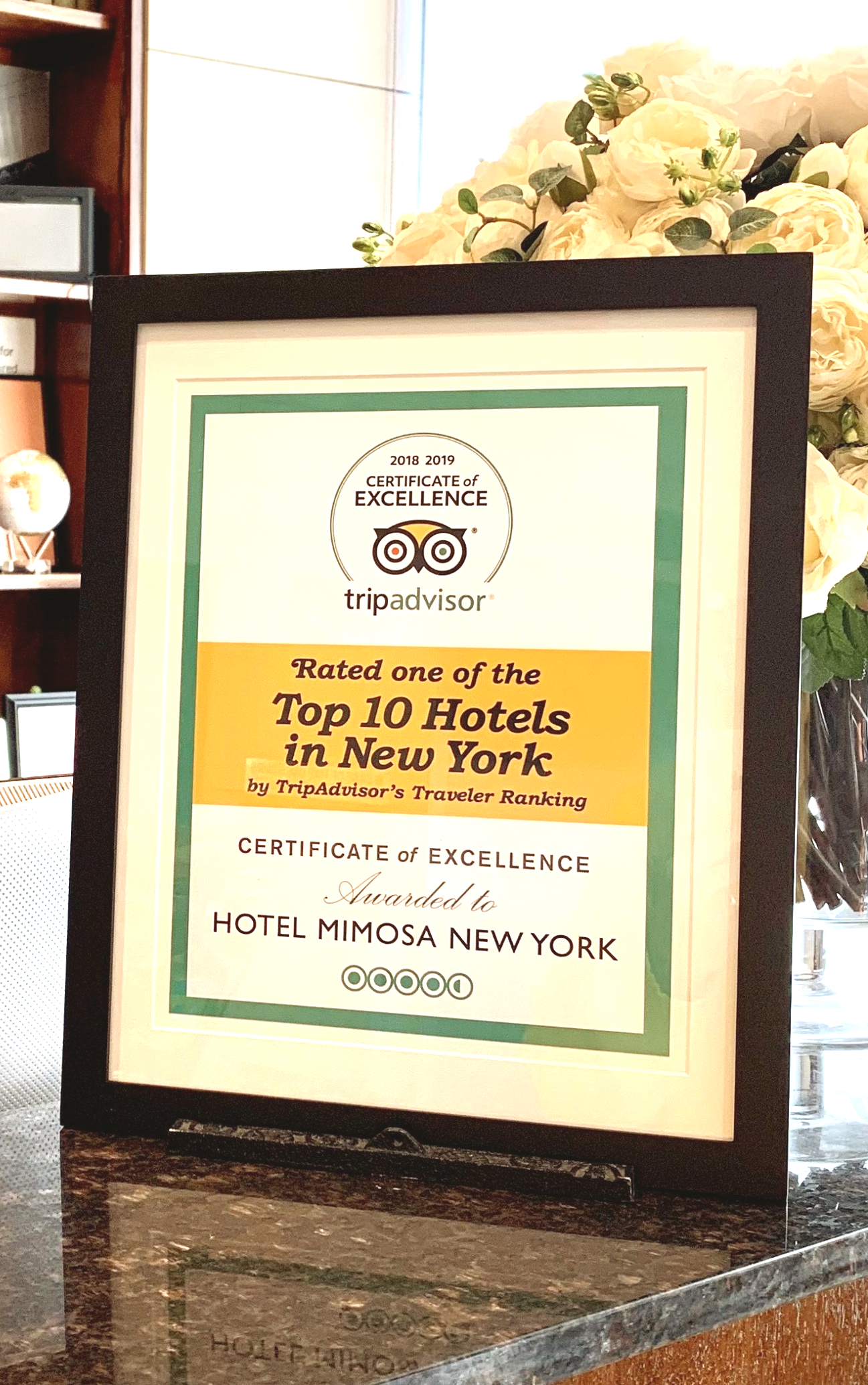 A framed sign that says top 10 hotels in new york