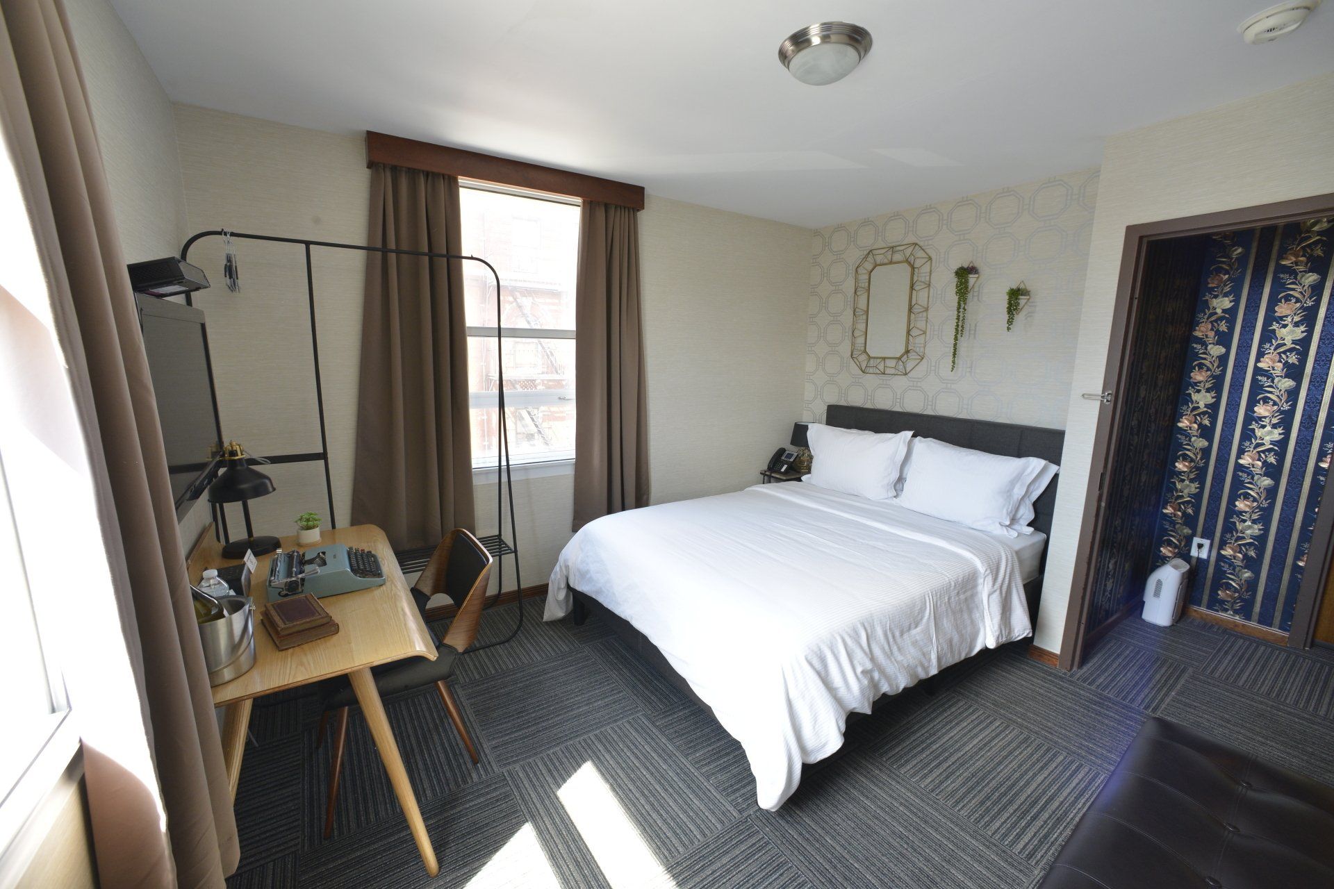A hotel room with a large bed and a desk