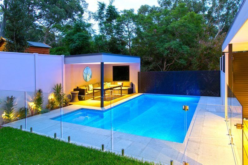 There Is A Large Swimming Pool In The Backyard Of A House — Dimension One Glass Fencing In Hunter Valley, NSW
