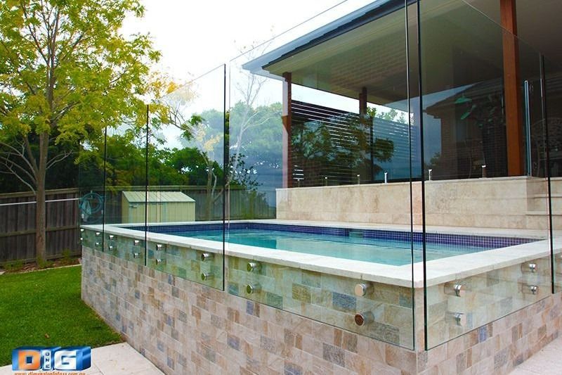 A Large Swimming Pool With A Glass Fence Around It — Dimension One Glass Fencing In Hunter Valley, NSW