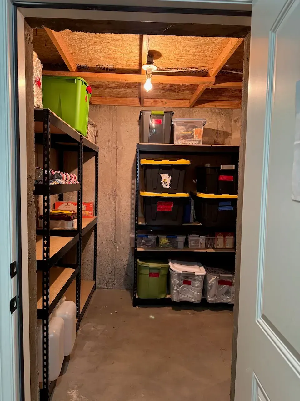 A room with a lot of shelves and bins in it