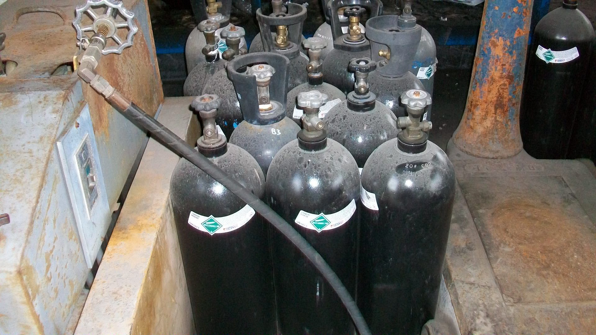 A bunch of gas cylinders are stacked on top of each other.