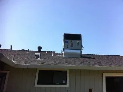 A house with a chimney on the roof and a window.