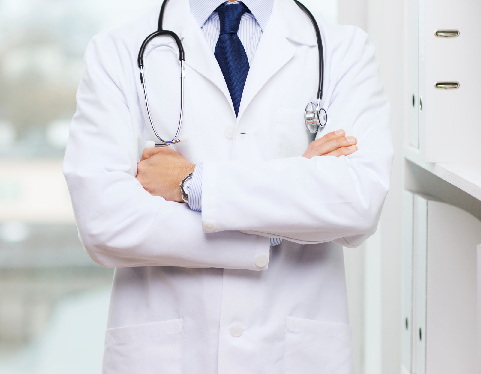 A person's arm being examined by a healthcare professional, likely for elbow pain.
