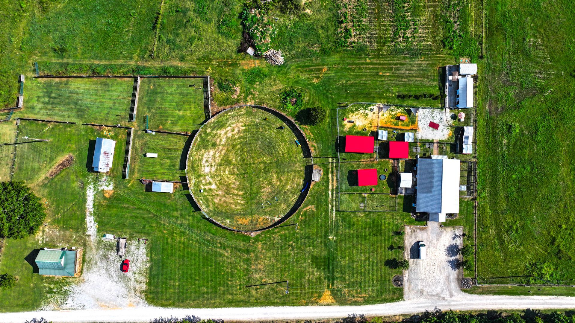 An aerial view of a farm with a circle in the middle of the field.