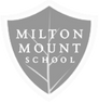 The logo for milton mount school is a shield with a leaf on it.