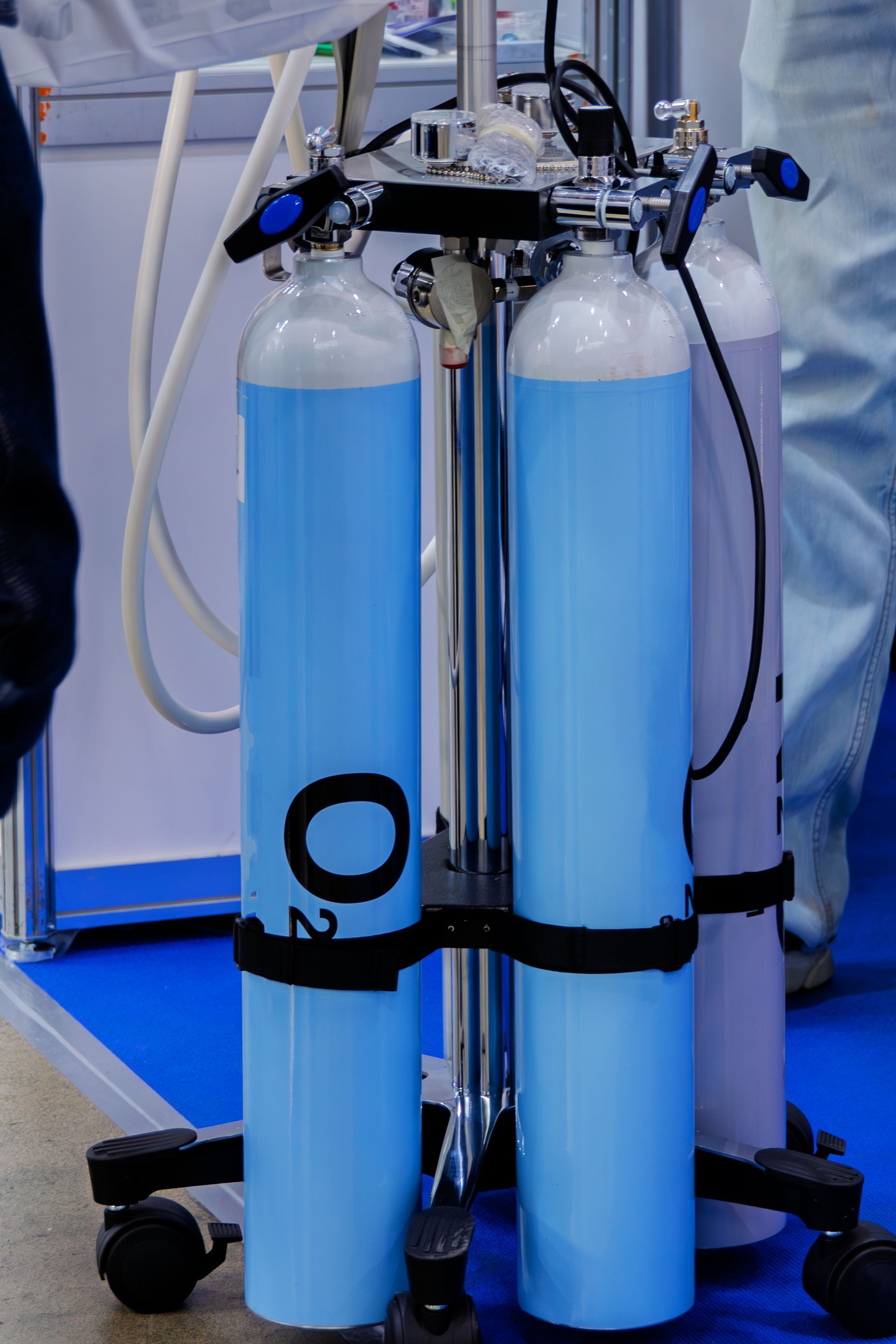 Medical oxygen cylinders on a mobile platform.