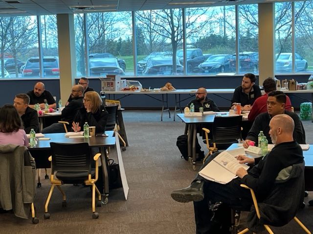 A group of people are sitting at tables in a room