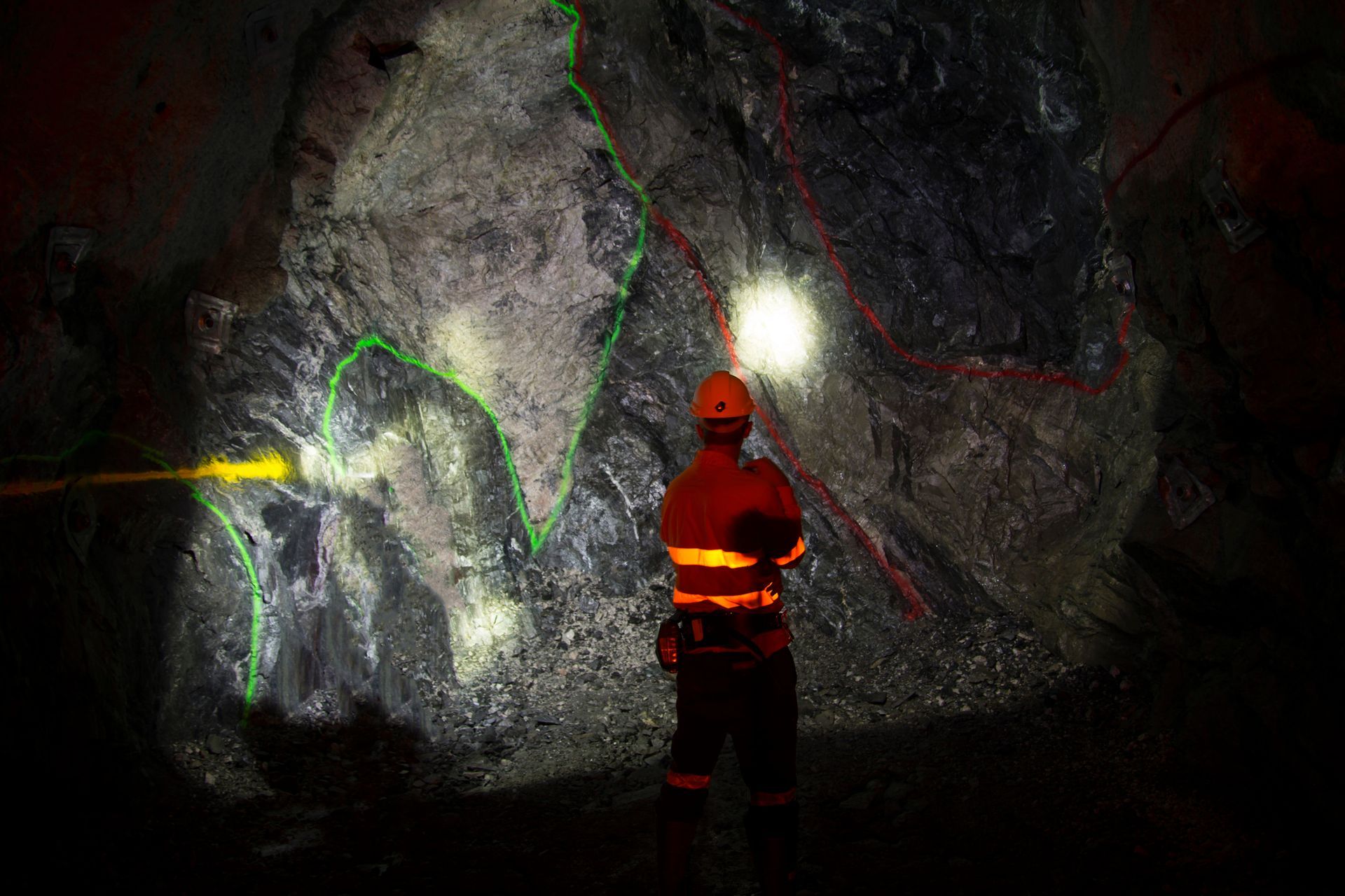 Rear view of worker standing in cave.