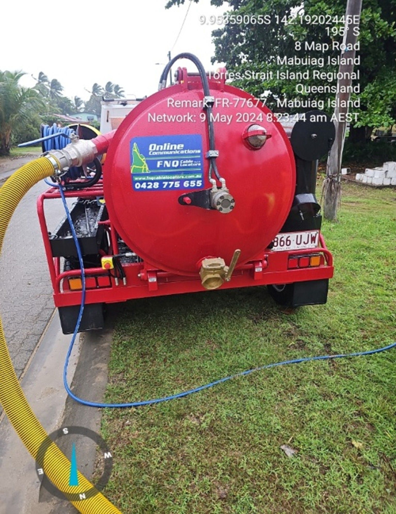 Red vacuum truck parked on a street, possibly for sewage, in Queensland.
