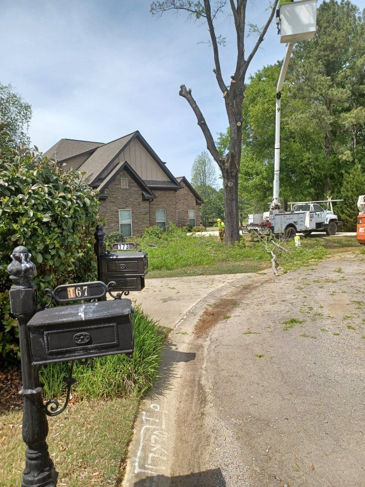 A mailbox is sitting on the side of the road next to a house.