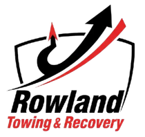 Logo for Rowland Towing & Recovery: black and red arrow over text in a shield.