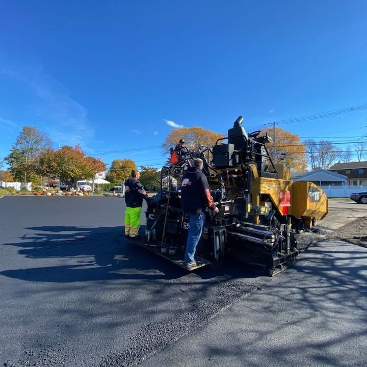 A group of construction workers are working on a road