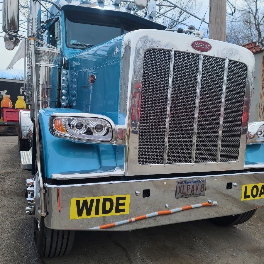 A blue truck with a yellow sign that says 