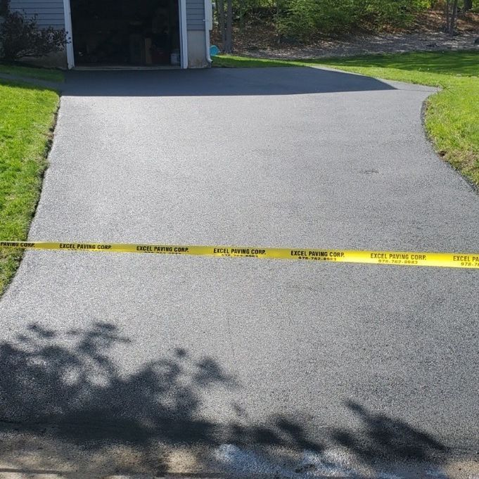 A driveway with a yellow tape that says do not enter
