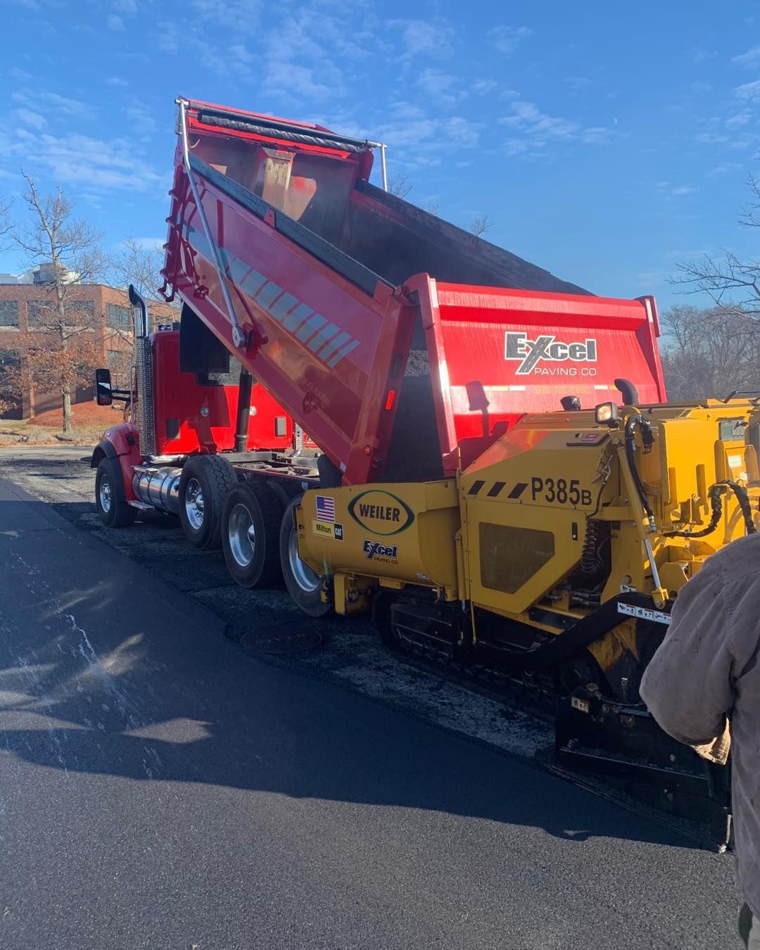 A red dump truck with the word eyzell on the back