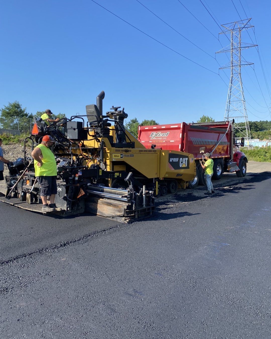 A group of construction workers are working on a road