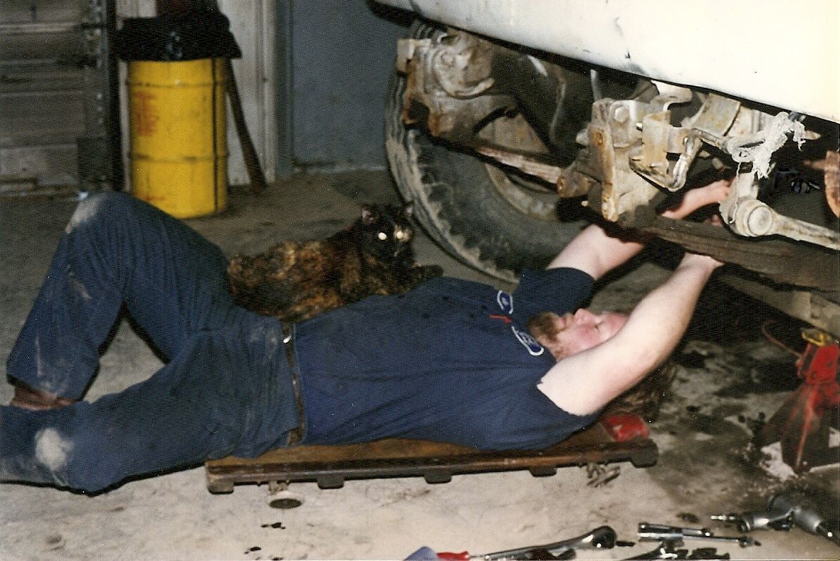 Man Working With Cat — Zanesville, OH — Goody’s Garage