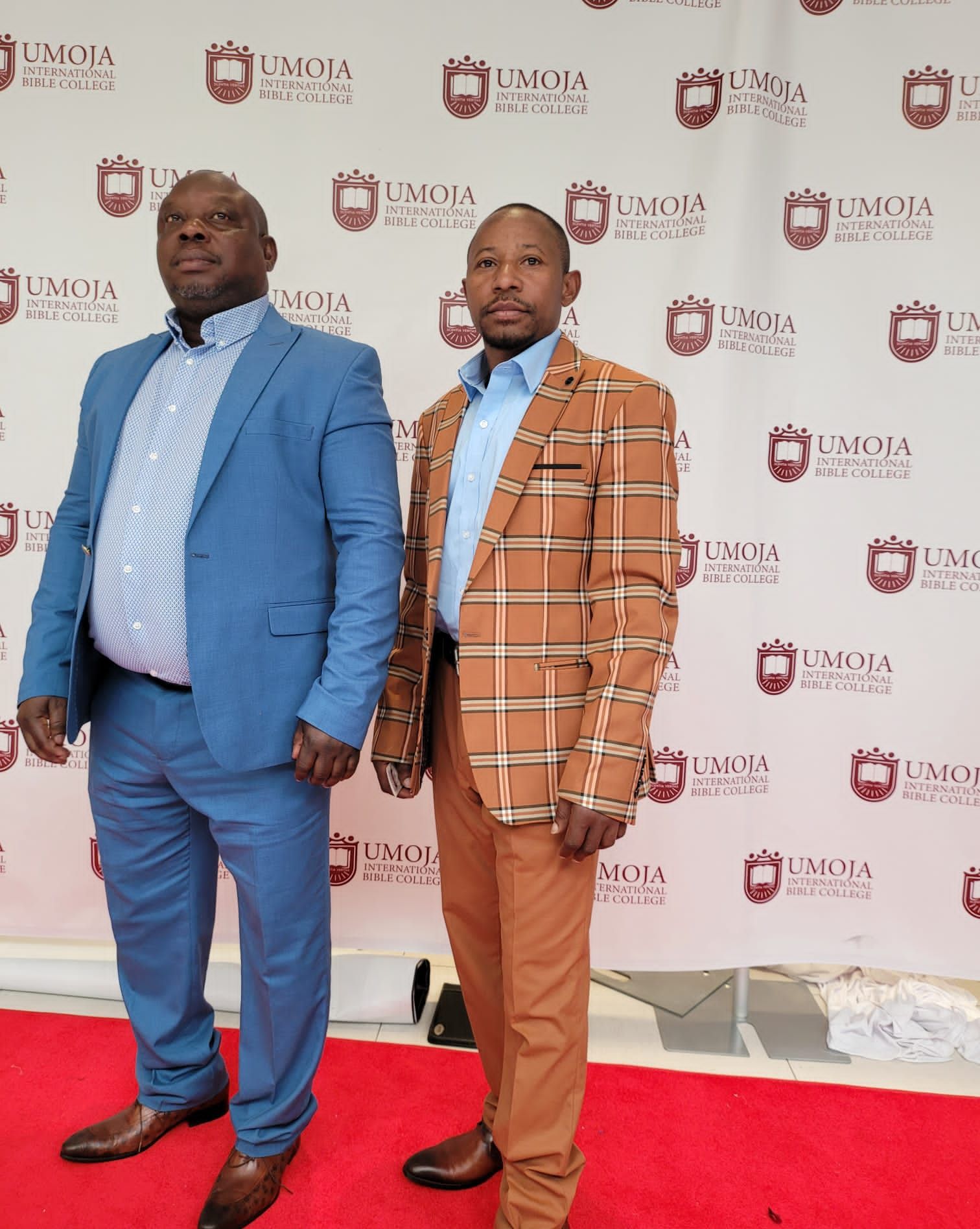 A man in a black suit is holding a bible