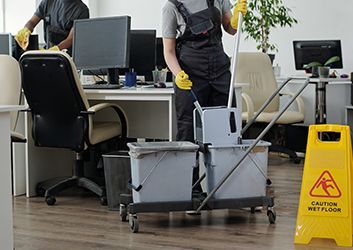A group of people are walking through a lobby in an office building.