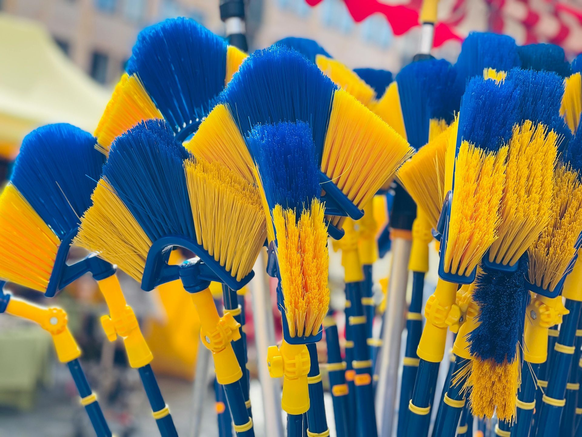 A bunch of blue and yellow brushes with yellow handles