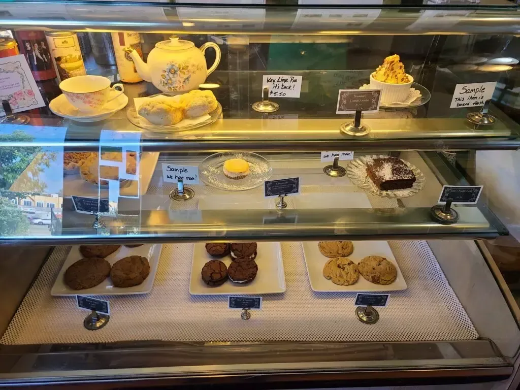 A display case filled with a variety of pastries and desserts.