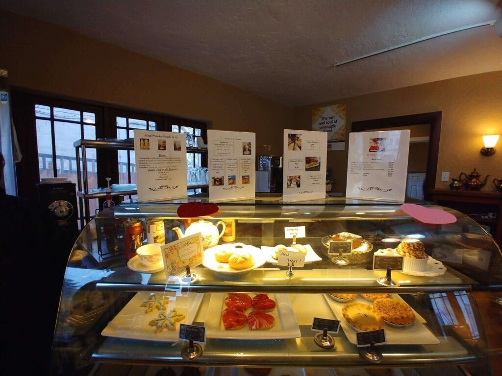A display case with a variety of desserts on it