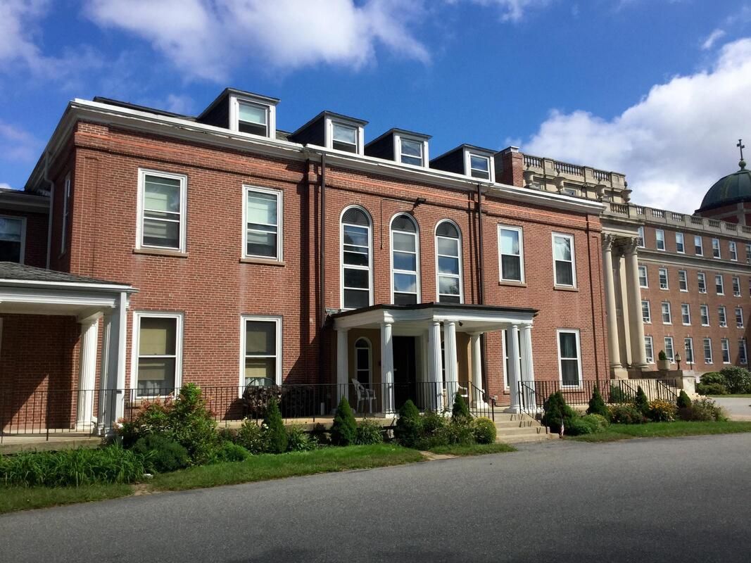 A large brick building with a dome on top of it