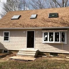 A house with a roof that has two skylights on it.