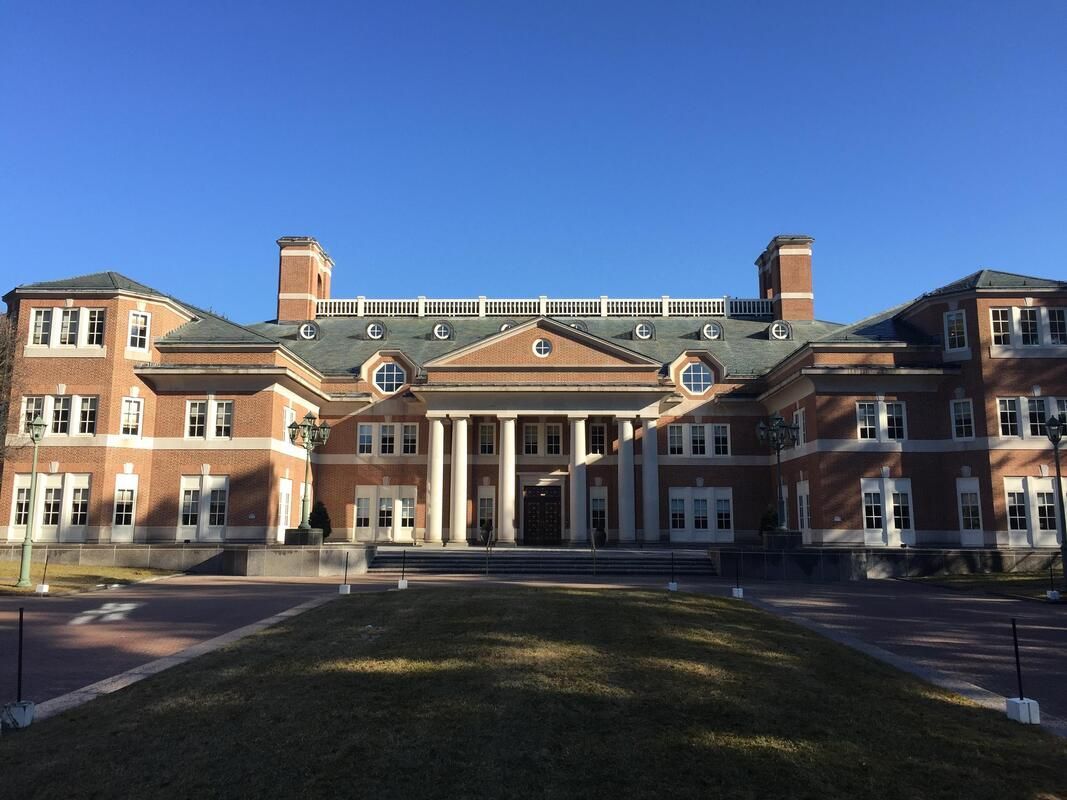 A large brick building with a blue sky in the background