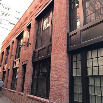 A brick building with a lot of windows on it