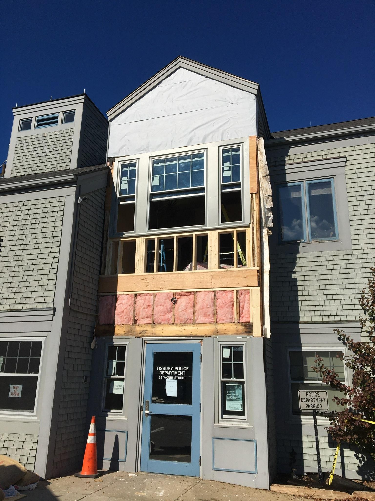 A building under construction with a blue door