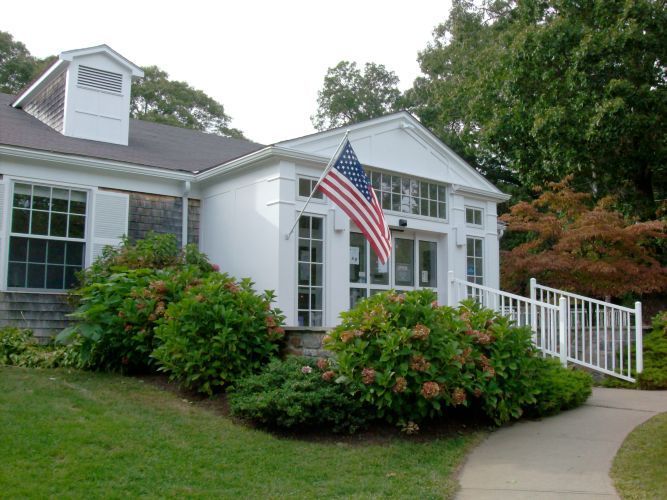 A white house with an american flag in front of it