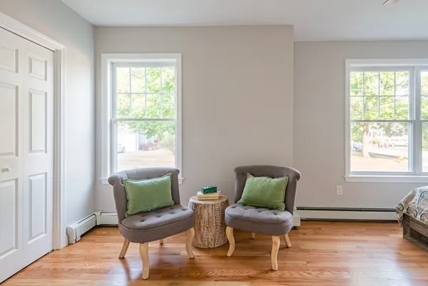 There are two chairs and a table in the room.