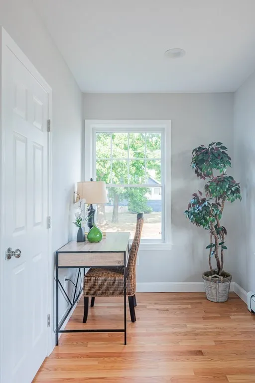 There is a desk and chair in the corner of the room.